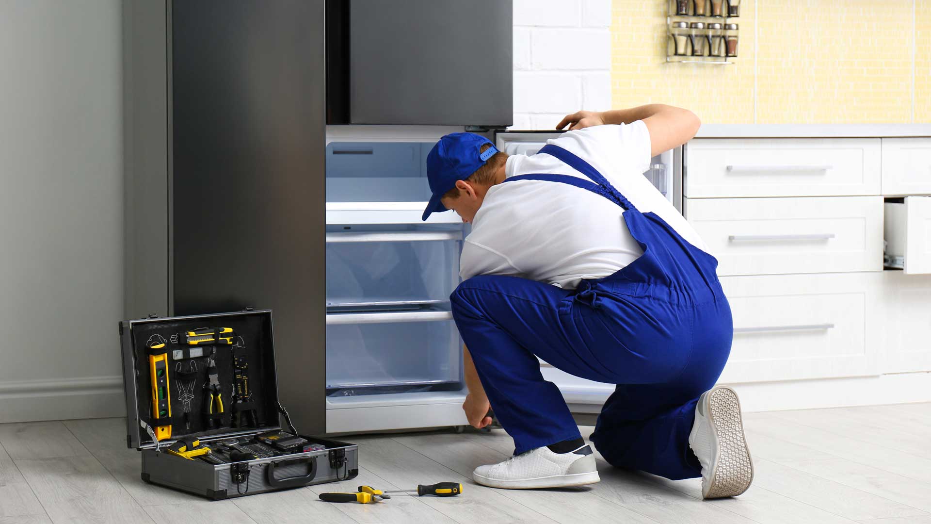Technician repairing fridge